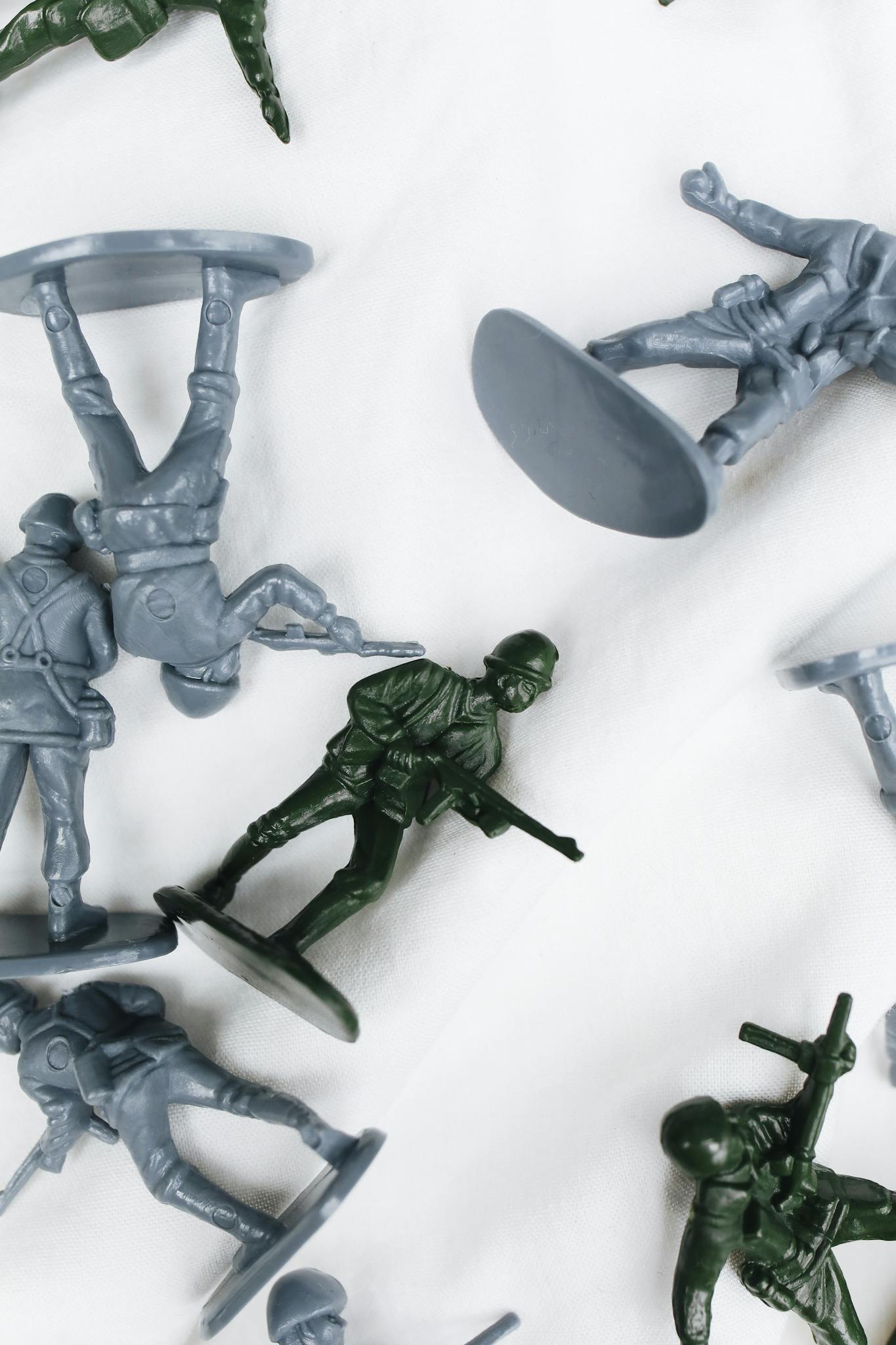 Top view of assorted plastic toy soldiers with varied poses, set against a white background.